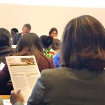 Audience members at ILC reading WIEGO's position paper, "Waste Pickers: The Right to be Recognized as Workers." Photo: Lucia Fernandez.